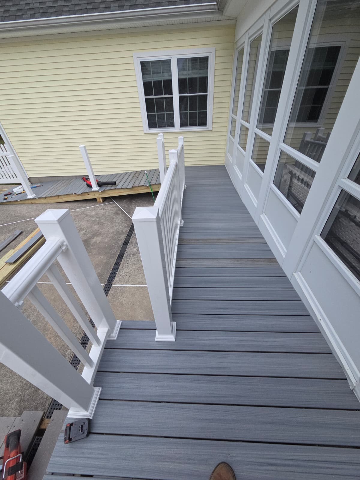 A Marco Solution & Services team member installing a composite deck and railing system